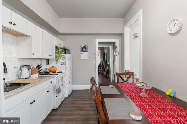 kitchen with sink, white appliances, dark wood-type flooring, white cabinetry, and decorative backsplash