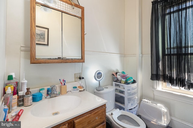 bathroom featuring vanity and toilet