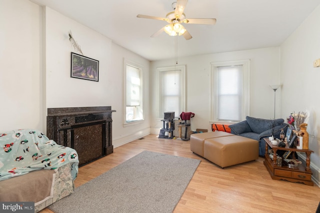 living room featuring light wood-type flooring and ceiling fan