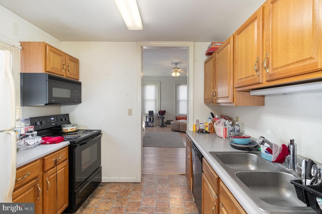 kitchen featuring black appliances, sink, light wood-type flooring, and ceiling fan