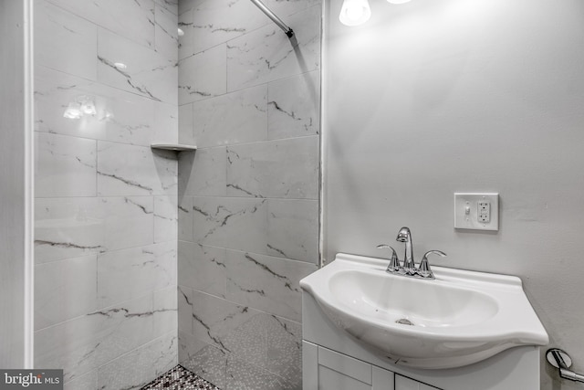 bathroom featuring vanity and a tile shower