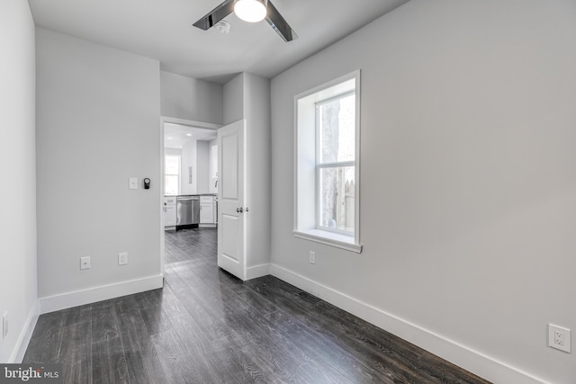 empty room with dark wood-type flooring and ceiling fan