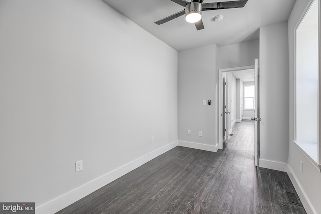 spare room featuring dark hardwood / wood-style floors and ceiling fan