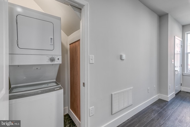 laundry area with stacked washer and clothes dryer and dark hardwood / wood-style flooring