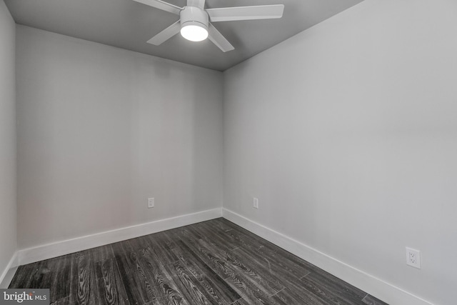 spare room featuring ceiling fan and dark wood-type flooring