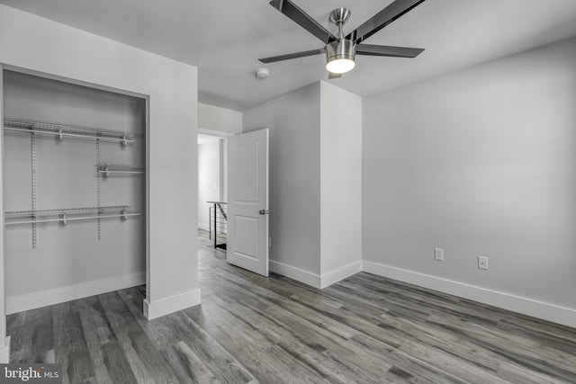 unfurnished bedroom featuring wood-type flooring, a closet, and ceiling fan