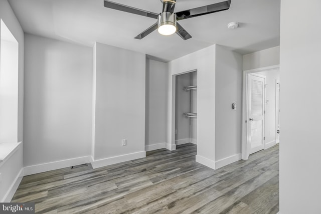 empty room with light wood-type flooring and ceiling fan