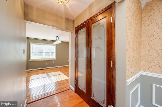 hall featuring french doors and wood-type flooring