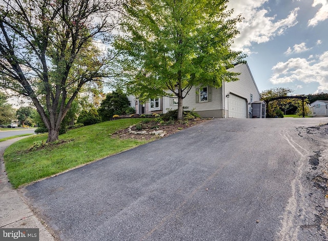 view of front of house with a front yard and a garage