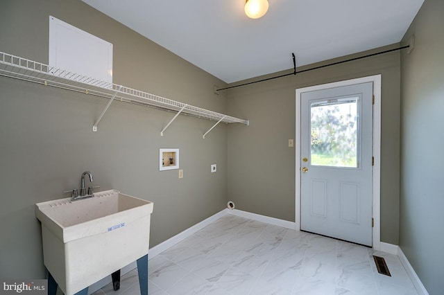 clothes washing area with washer hookup, sink, and hookup for an electric dryer