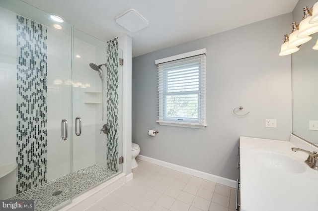 bathroom featuring vanity, tile patterned flooring, toilet, and a shower with shower door