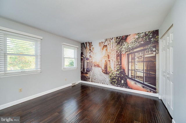 empty room with hardwood / wood-style floors