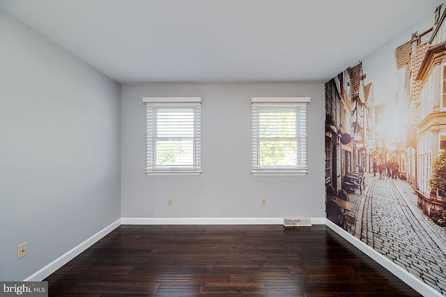 unfurnished room featuring dark hardwood / wood-style flooring