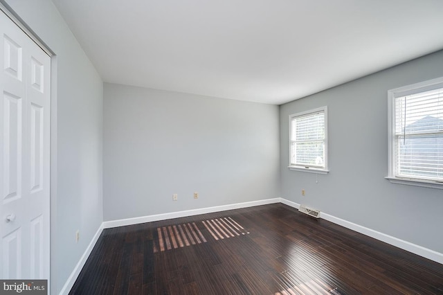 spare room with wood-type flooring