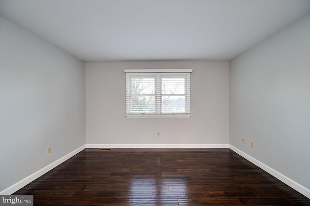 unfurnished room featuring dark hardwood / wood-style floors