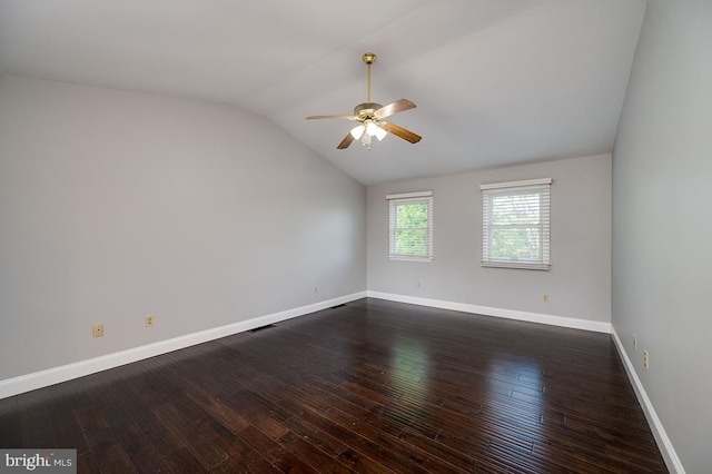 spare room with ceiling fan, dark wood-type flooring, and vaulted ceiling