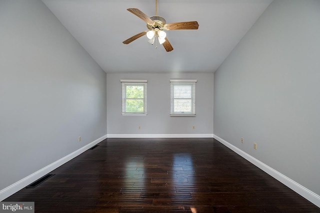 spare room with ceiling fan, lofted ceiling, and dark hardwood / wood-style floors