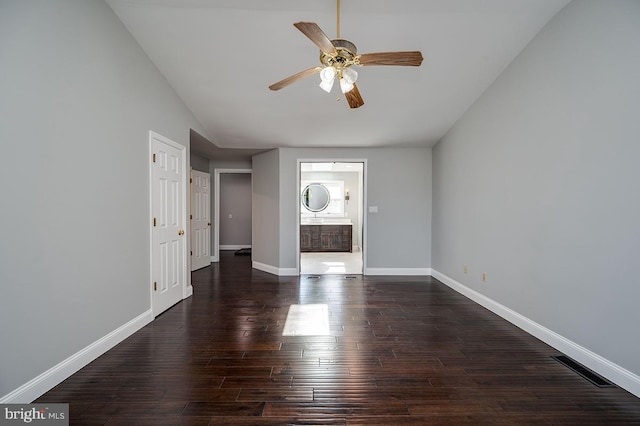 interior space featuring ceiling fan, lofted ceiling, and dark wood-type flooring