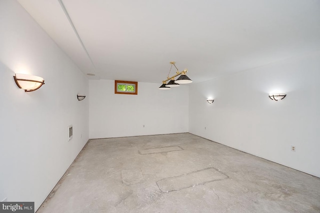 unfurnished room featuring concrete flooring