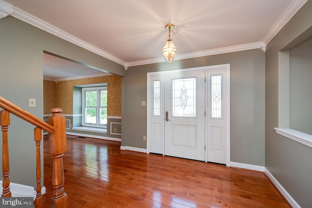 foyer entrance with wood-type flooring and ornamental molding