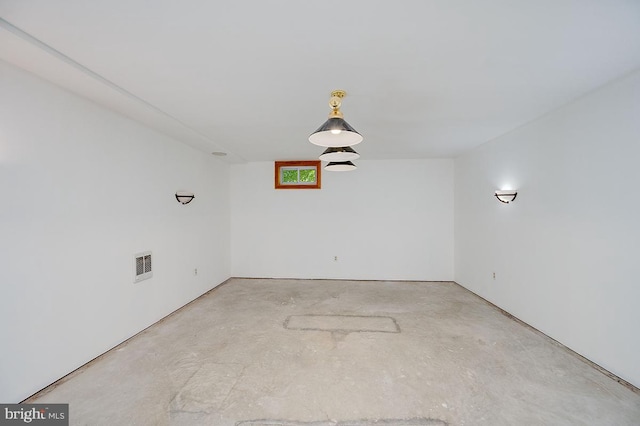 unfurnished room with concrete flooring