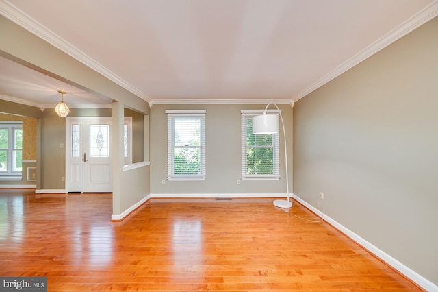 interior space with crown molding and light hardwood / wood-style flooring