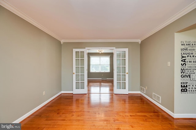 spare room with french doors, light hardwood / wood-style flooring, and crown molding