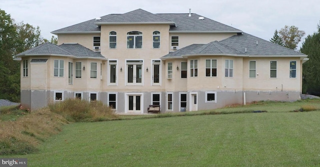 rear view of property featuring a yard