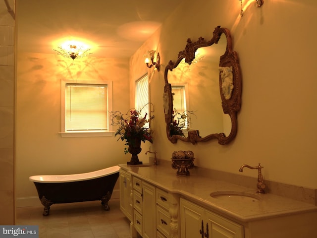 bathroom featuring tile patterned floors, a bathing tub, and vanity