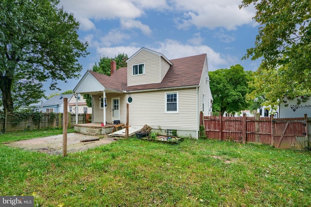 rear view of house with a patio area and a yard