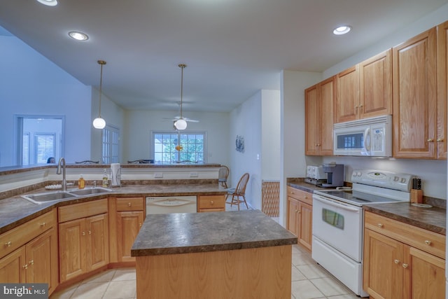 kitchen featuring a wealth of natural light, sink, white appliances, and a kitchen island