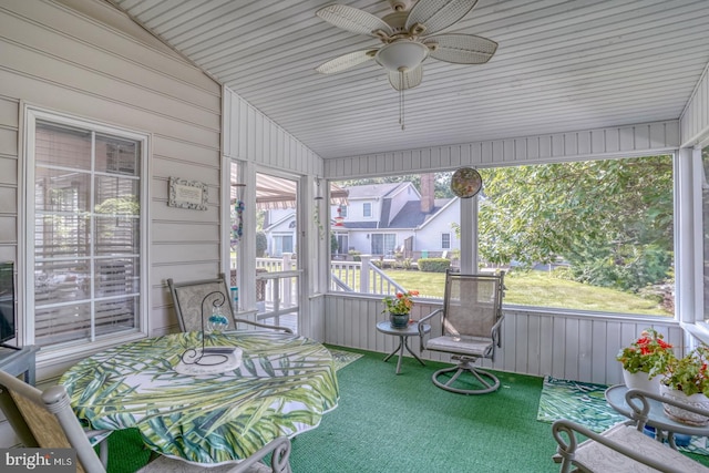 sunroom / solarium with ceiling fan and vaulted ceiling