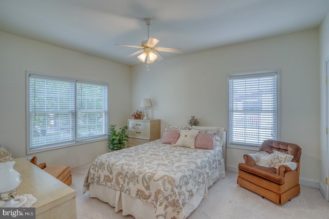 bedroom featuring light carpet and ceiling fan