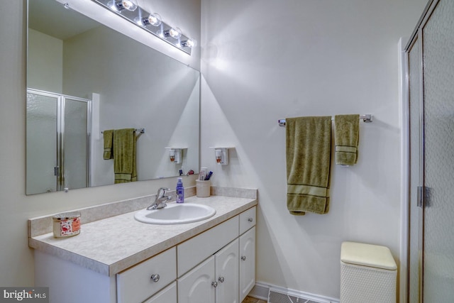 bathroom featuring an enclosed shower and vanity