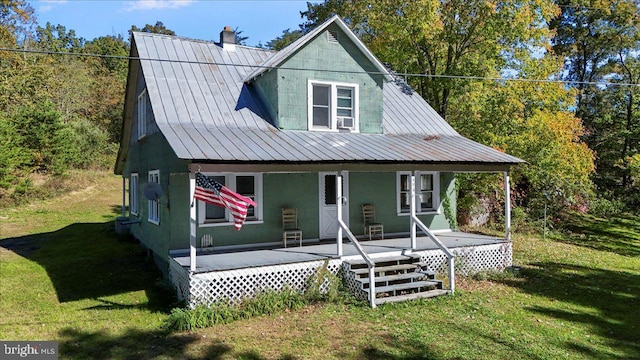 view of front of house featuring a porch, a front lawn, and cooling unit