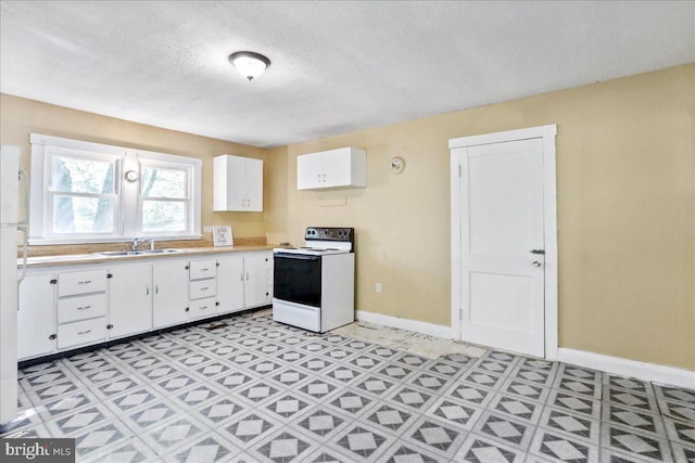 kitchen featuring white cabinets, a textured ceiling, sink, and white appliances