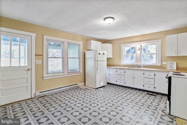 kitchen featuring sink, white appliances, a textured ceiling, white cabinetry, and a baseboard radiator