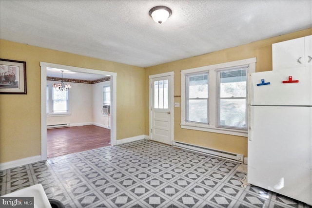 foyer entrance featuring an inviting chandelier, a baseboard radiator, and a textured ceiling