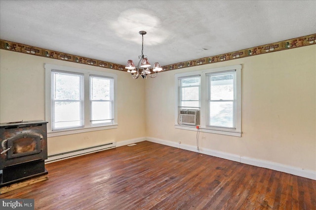 interior space with a baseboard radiator, dark wood-type flooring, a textured ceiling, and a healthy amount of sunlight