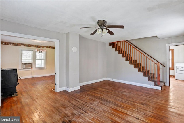 unfurnished living room with cooling unit, ceiling fan with notable chandelier, hardwood / wood-style floors, and washer / dryer