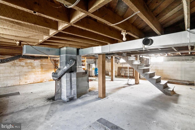 basement featuring water heater and heating unit