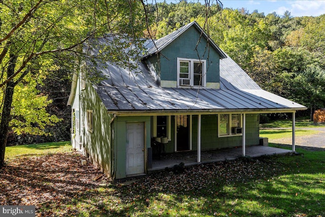 exterior space featuring a front lawn and cooling unit