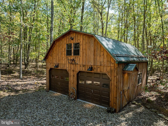 garage featuring wood walls