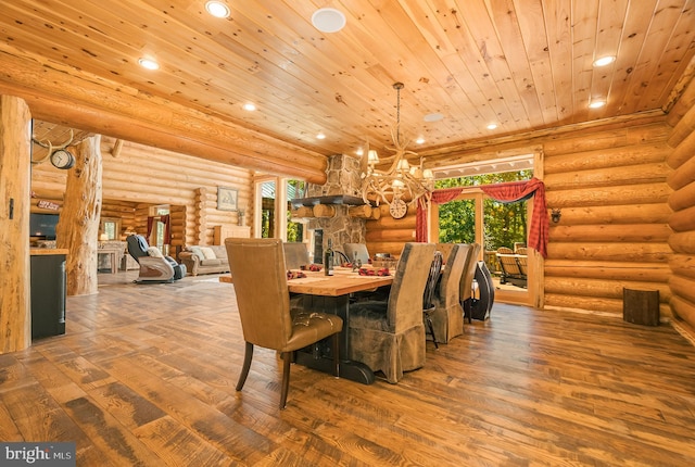 dining space with wood ceiling, wood-type flooring, and rustic walls