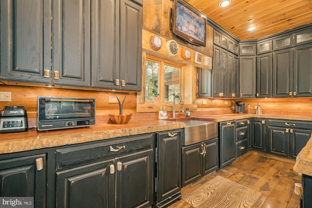 kitchen with wood ceiling, sink, and light wood-type flooring