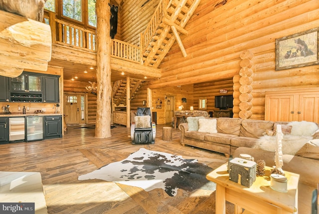 living room with log walls, a high ceiling, wine cooler, and wood-type flooring