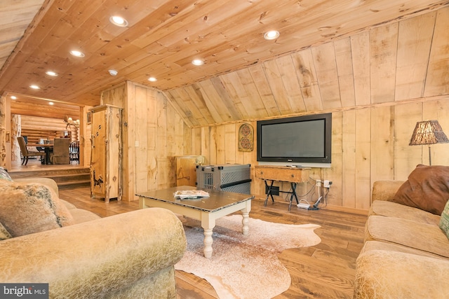 living room featuring lofted ceiling, wood ceiling, light hardwood / wood-style floors, and wood walls