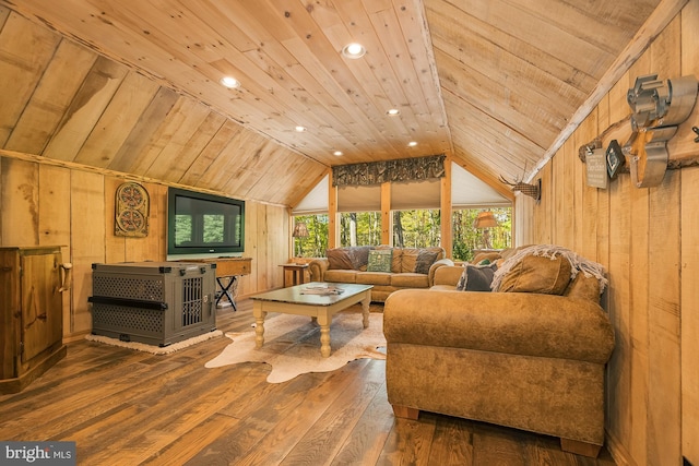 living area with hardwood / wood-style floors, vaulted ceiling, and wood walls