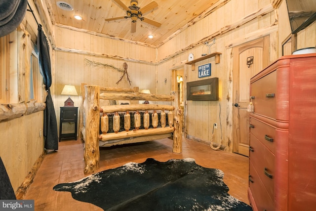 bedroom featuring wood ceiling and wooden walls