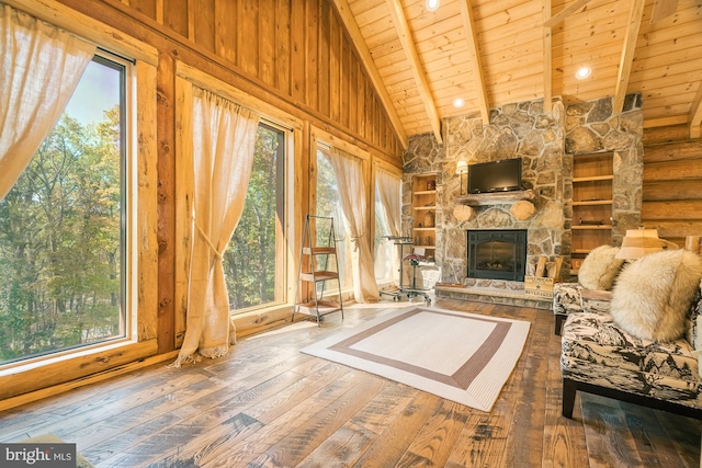 unfurnished living room featuring a healthy amount of sunlight, hardwood / wood-style flooring, and a fireplace